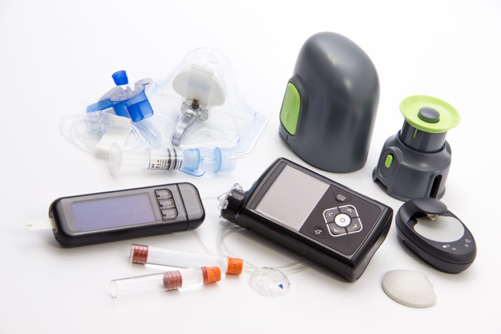 Various diabetes monitoring devices on a white background.